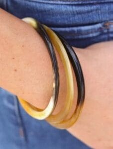 Cedar and Cypress Horn Bangle. Shown in stack of three on model's wrist.