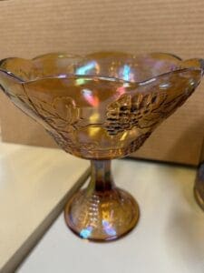 Amber glass grape bowl on pedestal.