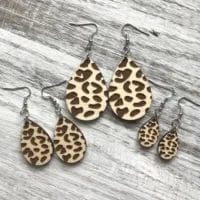 Holly and Liz Maple Wood Leopard Drop Earrings in a group of 3. Teardrop shaped earrings laser cut from wood with a maple finish