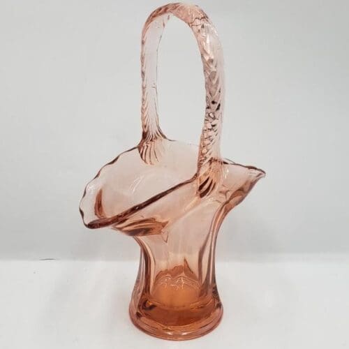 Pink glass basket with handle.