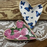 Two heart-shaped trinket dishes; flowers, butterflies.