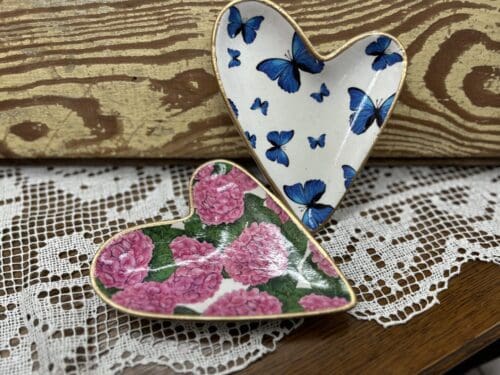 Two heart-shaped trinket dishes; flowers, butterflies.