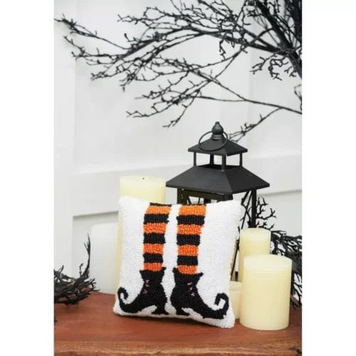 Small throw pillow with witches boots and legs showing