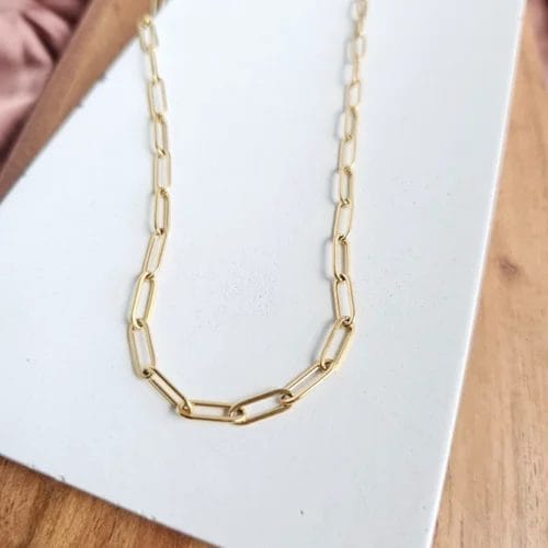 18K Gold Paperclip Chain Necklace laying on a white background.