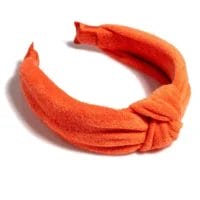 Shiraleah Knotted Spa Headband in Orange- a cotton terry headband knotted at the crown, shown on a white background