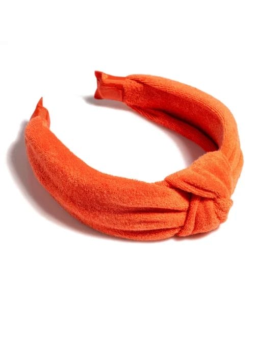 Shiraleah Knotted Spa Headband in Orange- a cotton terry headband knotted at the crown, shown on a white background