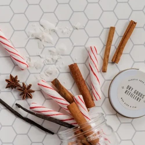 Candy canes, cinnamon, and vanilla in jar.