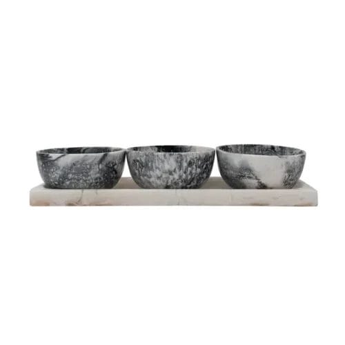 Marble serving tray with three bowls.