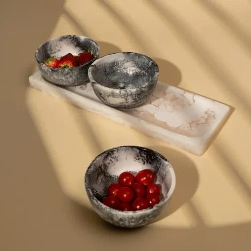 Stoneware bowls with berries on tray