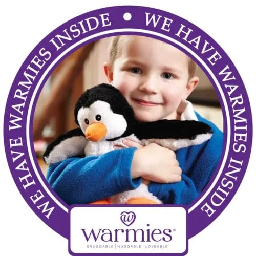 Child hugging a penguin Warmies.